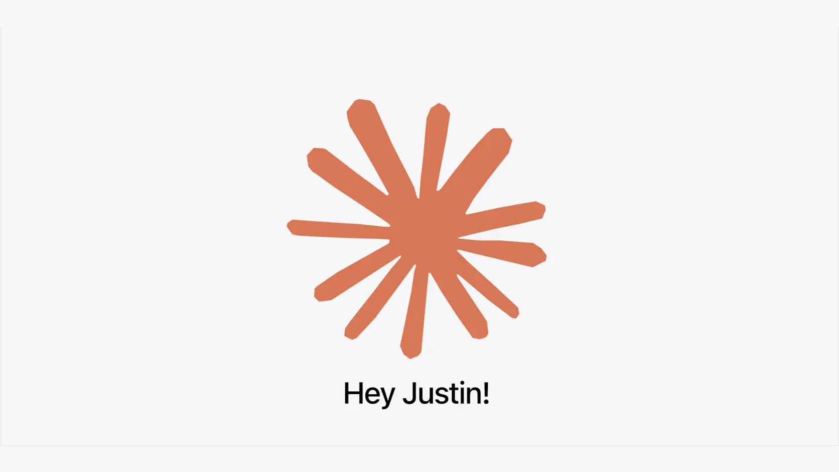 An orange hand drawn starburst with twelve uneven rays on a pale grey background, with the words "Hey Justin!" in black beneath it.