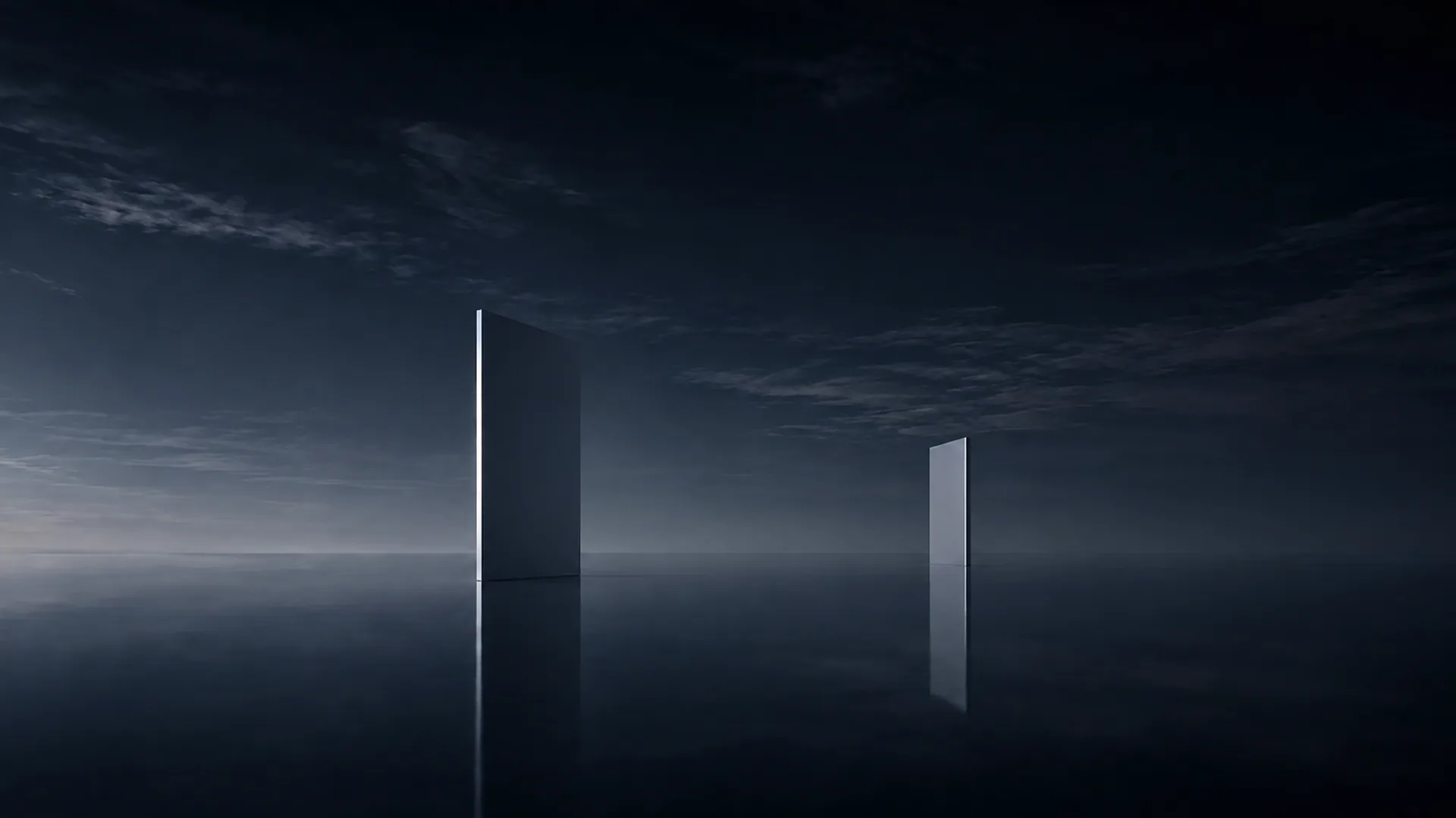 Two pale upright slabs, one tall and one small, standing apart on a dark mirrored plane beneath a dim blue clouded sky.