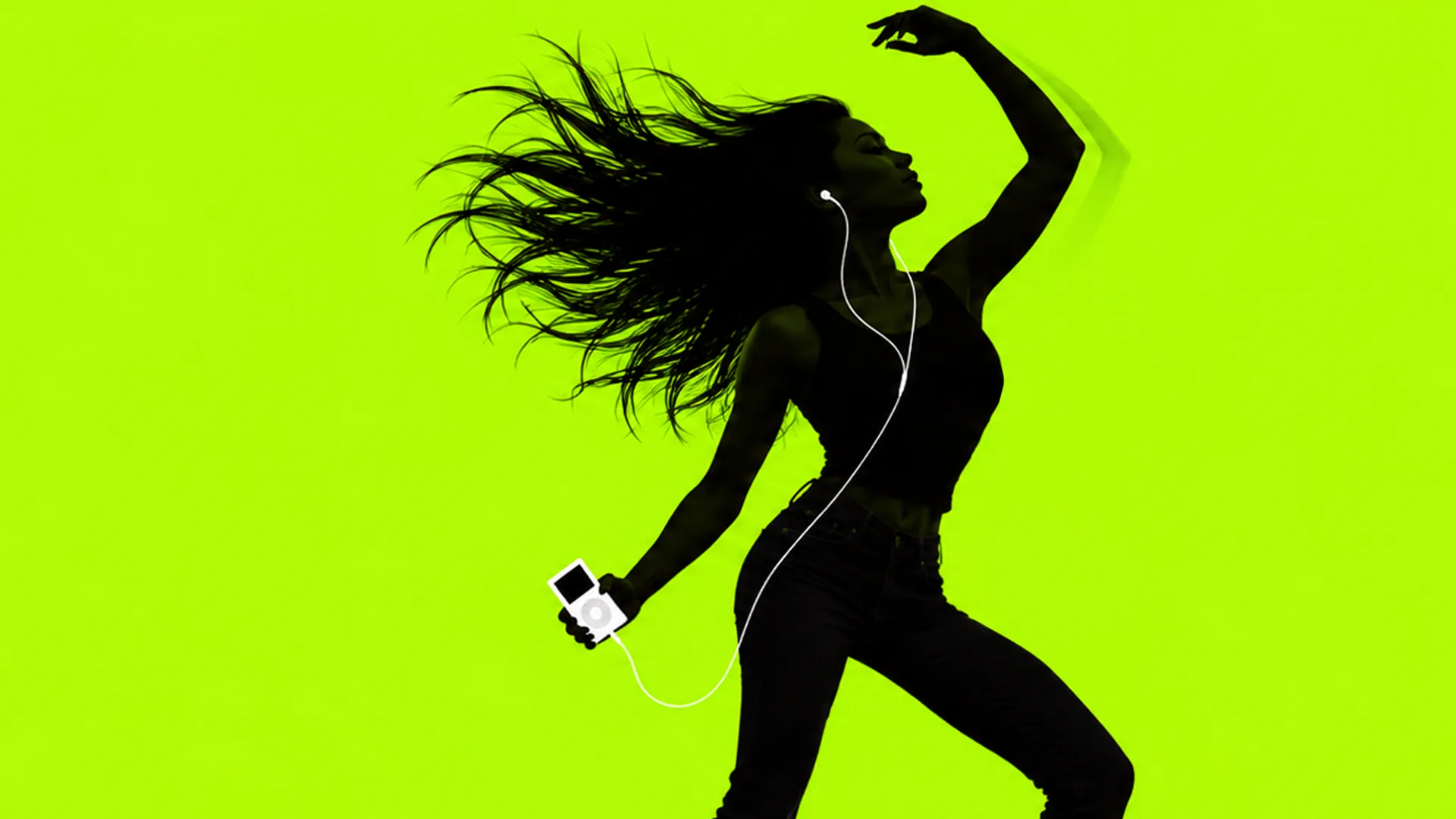 A black silhouette of a person with long spread hair, one arm raised, holding a small white device with white earbud cords, on lime green.