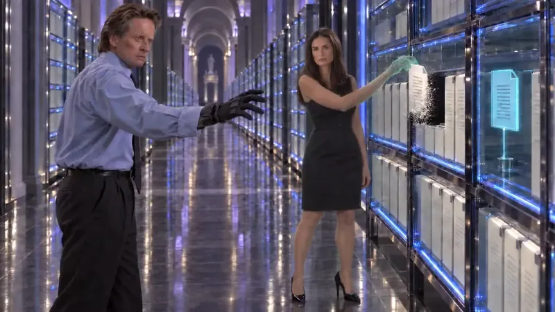 A man in a blue shirt and black glove reaches out in a glowing blue corridor as a woman pulls a file from lit shelves.