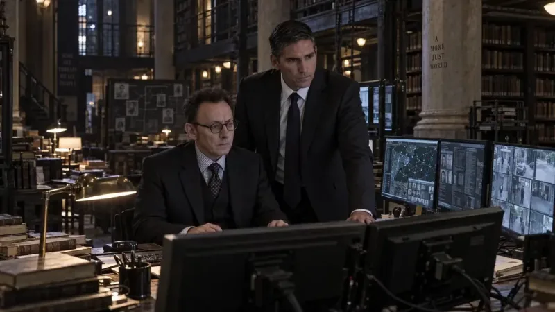 Two people in suits at a desk of monitors showing faces and a network map, in a dim library, the wall reading SOME SEE THREATS WE SEE PEOPLE.